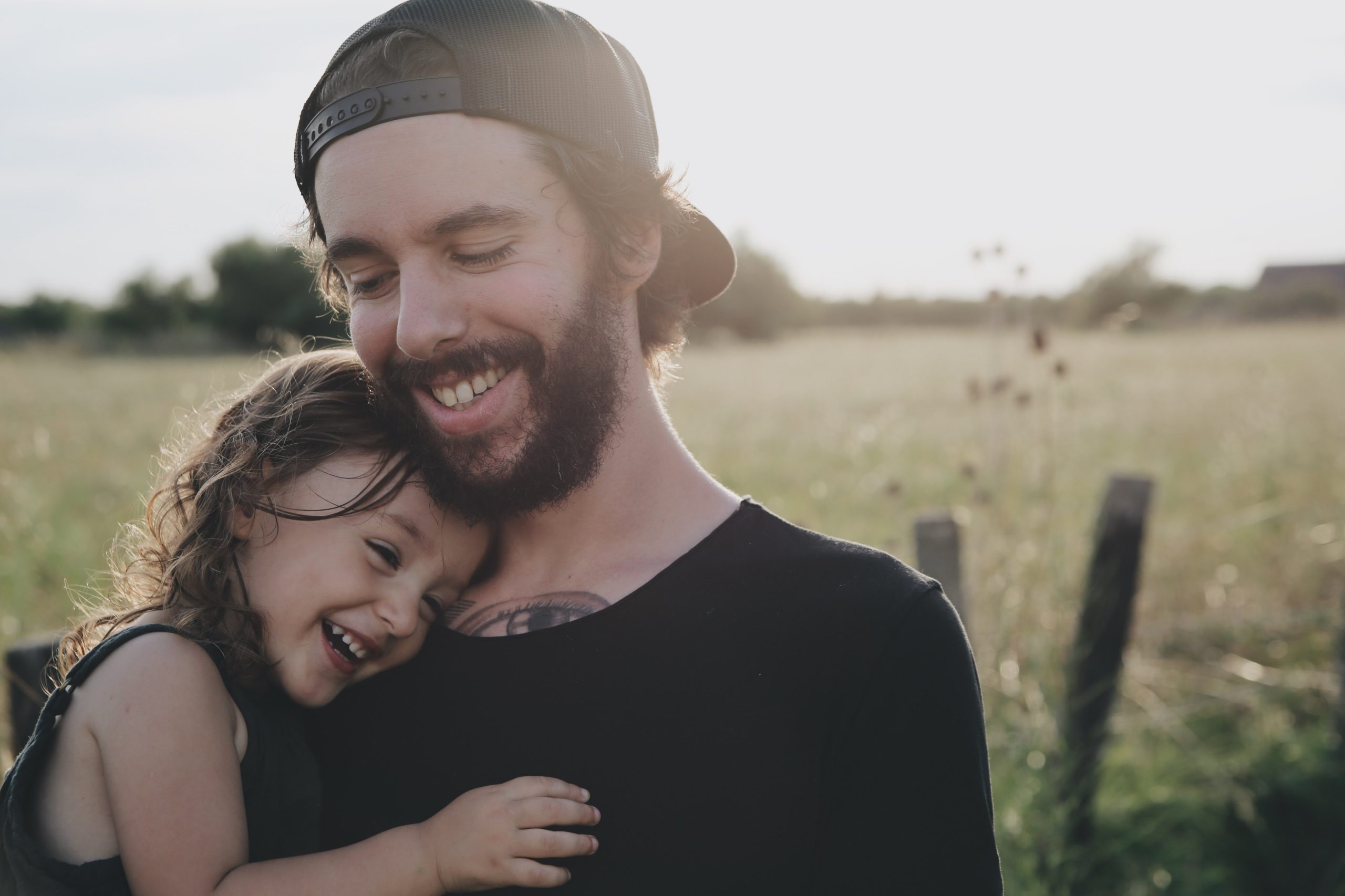 dad holding and hugging his young daughter